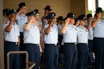 Col. Michael Power, 377th Air Base Wing commander, and Chief Master Sgt. Antonio Cooper, 377 ABW command chief, salute during the national anthem at Joint Base San Antonio-Lackland, Texas, March 14, 2024. The command team was invited to be this graduating class’s reviewing officials during the ceremony. (U.S. Air Force photo by Senior Airman Ruben Garibay)