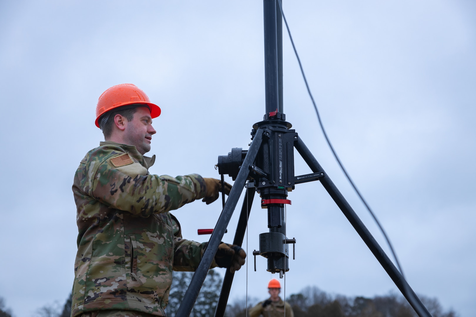 Connecticut Air National Guard Master Sgt. Jonathan Wolff, an expeditionary warfighting communications Airman assigned to the 103rd Air Control Squadron, or 103rd ACS, cranks the handle of an antenna mast, part of the Tactical Operations Center - Light, or TOC-L, at Camp Nett, Niantic, Connecticut, March 5, 2024. Airmen from the 103rd ACS are testing the TOC-L system for the U.S. Air Force.