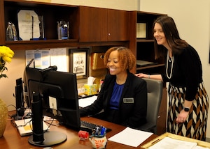 Myaleca Malone, left, Air Force Reserve Command's Small Business Program director, works with Carol Elliott, a small business professional in AFRC's Policy Office. (U.S. Air Force photo by Bo Joyner)