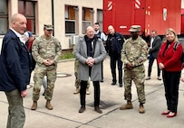 Mannheim Lord Mayor Christian Specht (middle) stands between Lt. Col. Omar McKen, the commander of Army Field Support Battalion-Poland, and Lt. Col. David Castillo, the U.S. Army Garrison Rheinland-Pfalz director of emergency services, during Specht’s site visit to the Coleman Army Prepositioned Stocks-2 worksite in Mannheim, Germany, March 15. The Lord Mayor visited the worksite to observe APS-2 operations and gain a clear understanding of the upcoming infrastructure upgrades and the associated economic, environmental and social impacts on the area. (Photo by Chris Maestas, USAG Rheinland-Pfalz PAO)