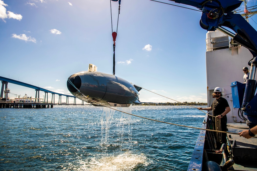 Mariners aboard the research vessel Bold Horizon recover a launched large displacement unmanned undersea vehicle  in San Diego Bay during Integrated Battle Problem.