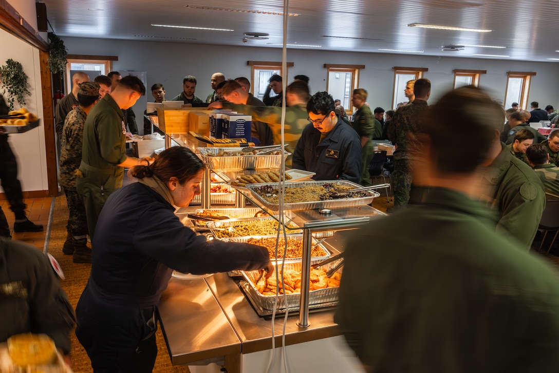 U.S. Marines with 2nd Marine Aircraft Wing serve themselves food alongside NATO allies and partners during Exercise Nordic Response 24 at Andenes, Norway, March 14, 2024. Exercise Nordic Response is designed to enhance military capabilities and allied cooperation in high-intensity warfighting scenarios under challenging arctic conditions, while providing U.S. Marines unique opportunities to train alongside NATO allies and partners. (U.S. Marine Corps photo by 2nd Lt. Duncan Stoner)