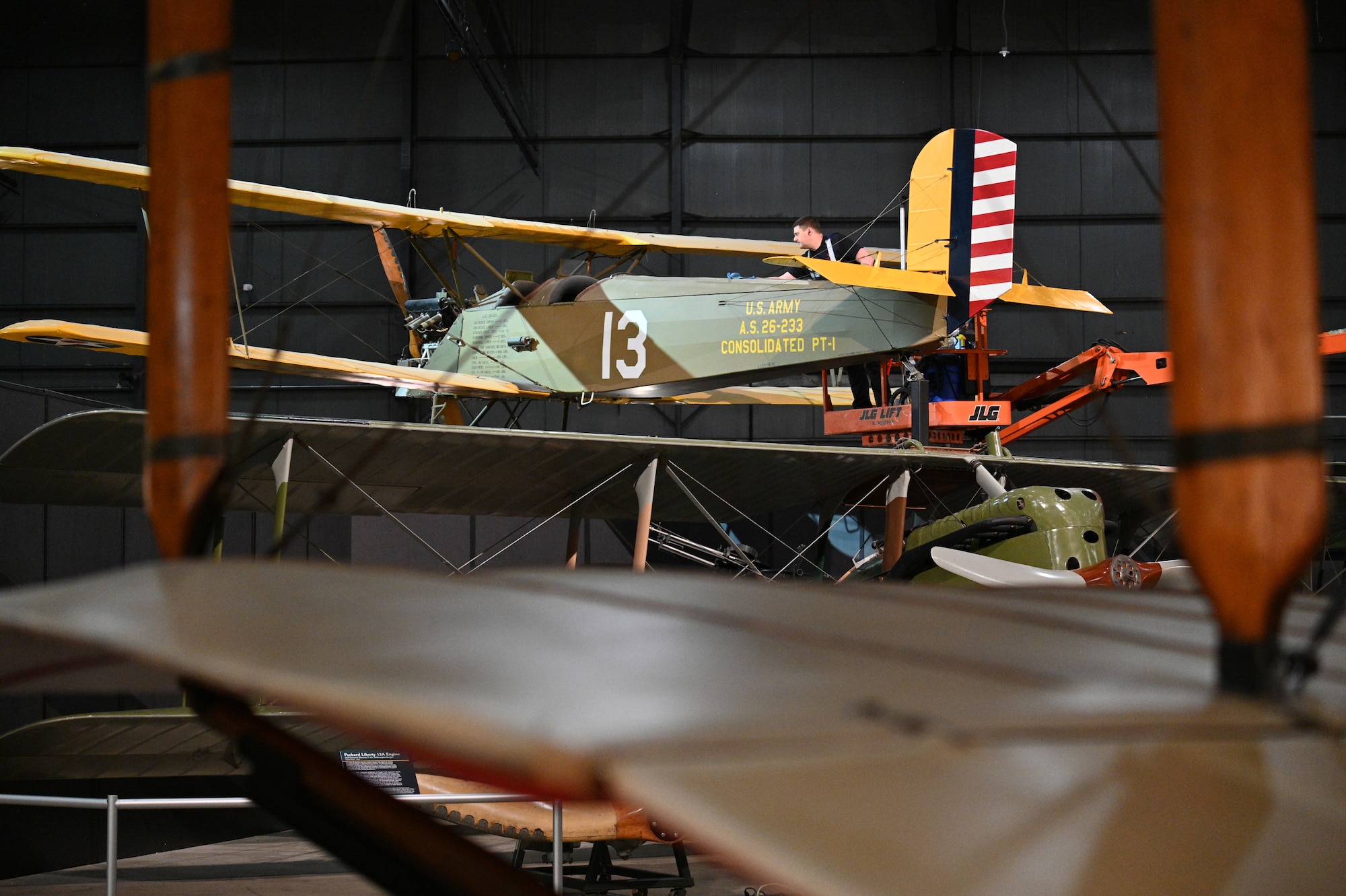 Nick Almeter cleans the Consolidated PT-1 Trusty aircraft.