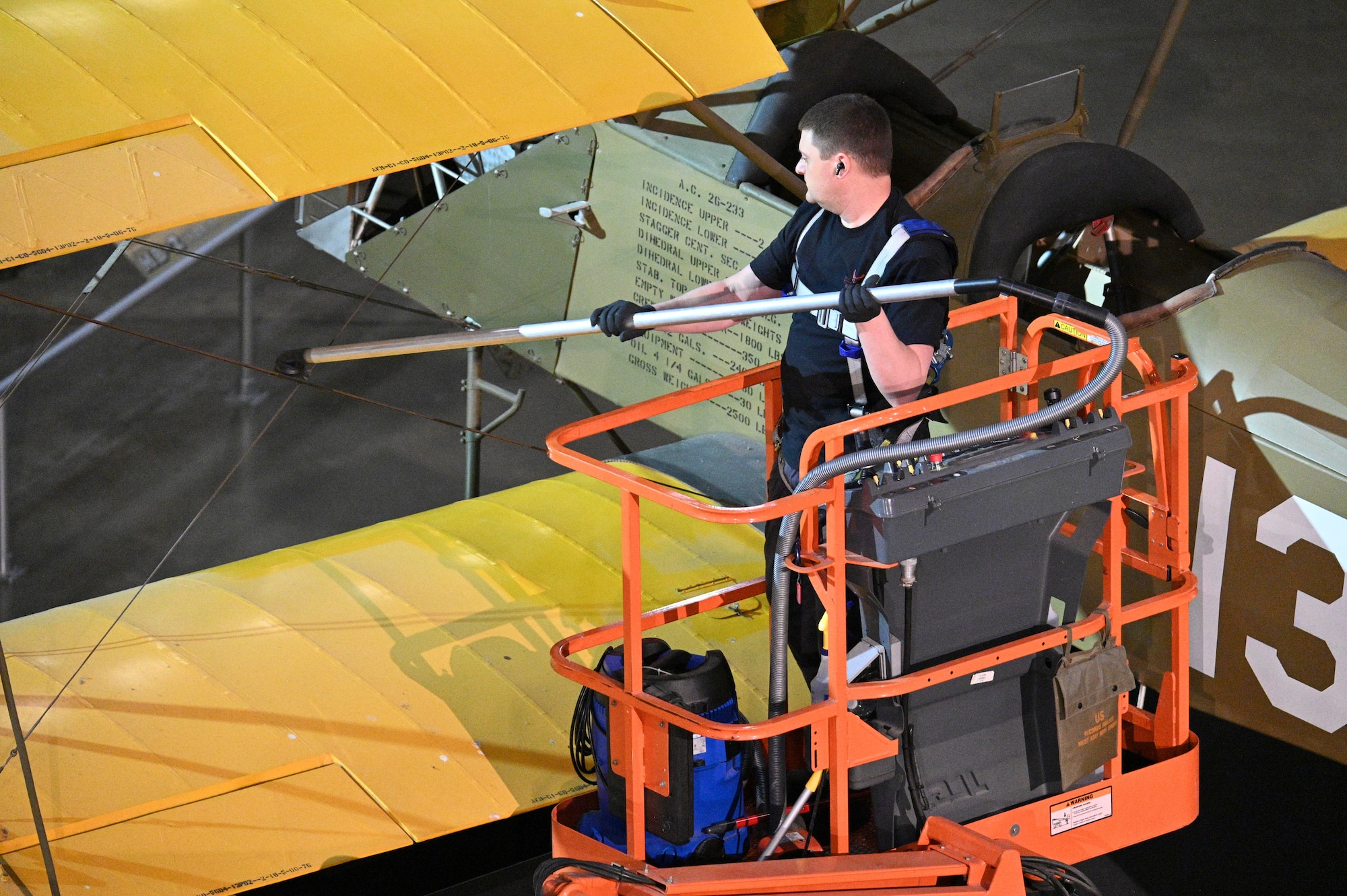 Nick Almeter cleans the Consolidated PT-1 Trusty aircraft.