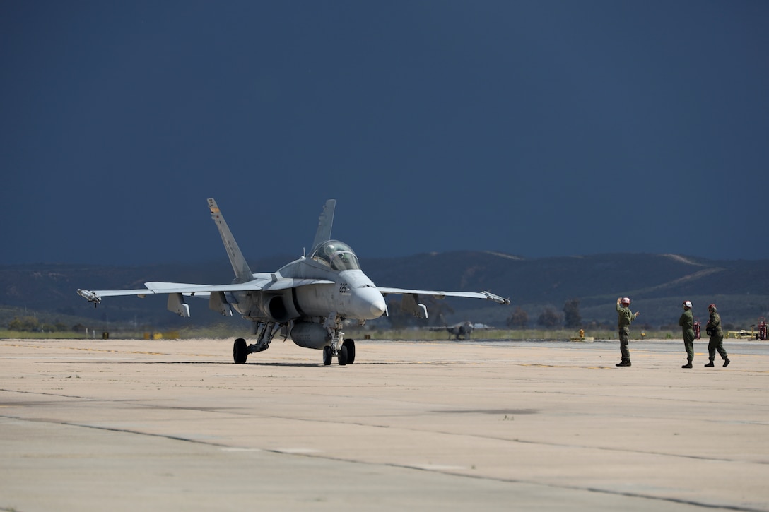 A U.S. Marine Corps F/A-18D Hornet assigned to Marine Fighter Attack Squadron (VMFA) 323, Marine Aircraft Group 11, 3rd Marine Aircraft Wing, taxis after a section engaged maneuvering flight at Marine Corps Air Station Miramar, California, March 18, 2024. This was the final training flight for Capt. Michael LoGrande, a student weapons systems officer with VMFA-323, before becoming the last student to graduate the Marine Corps WSO course on March 22, 2024. (U.S. Marine Corps photo by Sgt. Sean Potter)