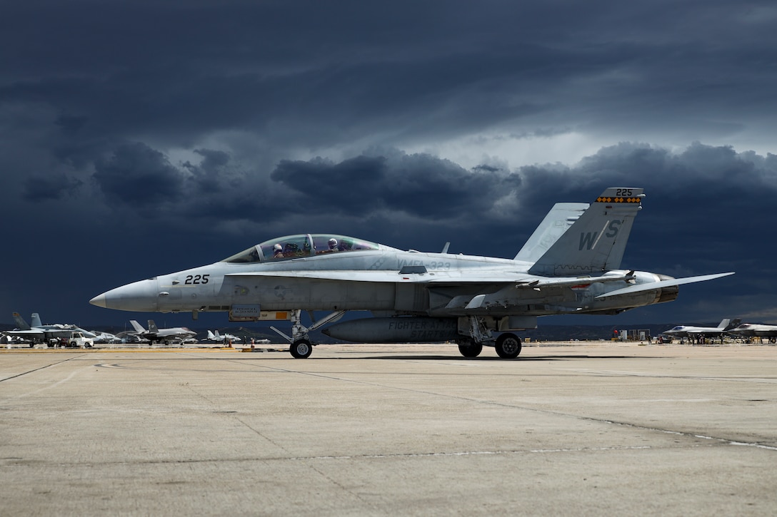 A U.S. Marine Corps F/A-18D Hornet assigned to Marine Fighter Attack Squadron (VMFA) 323, Marine Aircraft Group 11, 3rd Marine Aircraft Wing, taxis after a section engaged maneuvering flight at Marine Corps Air Station Miramar, California, March 18, 2024.  This was the final training flight for Capt. Michael LoGrande, a student weapons systems officer with VMFA-323, before graduating on March 22, 2024, as the Marine Corps last WSO. (U.S. Marine Corps photo by Sgt. Sean Potter)