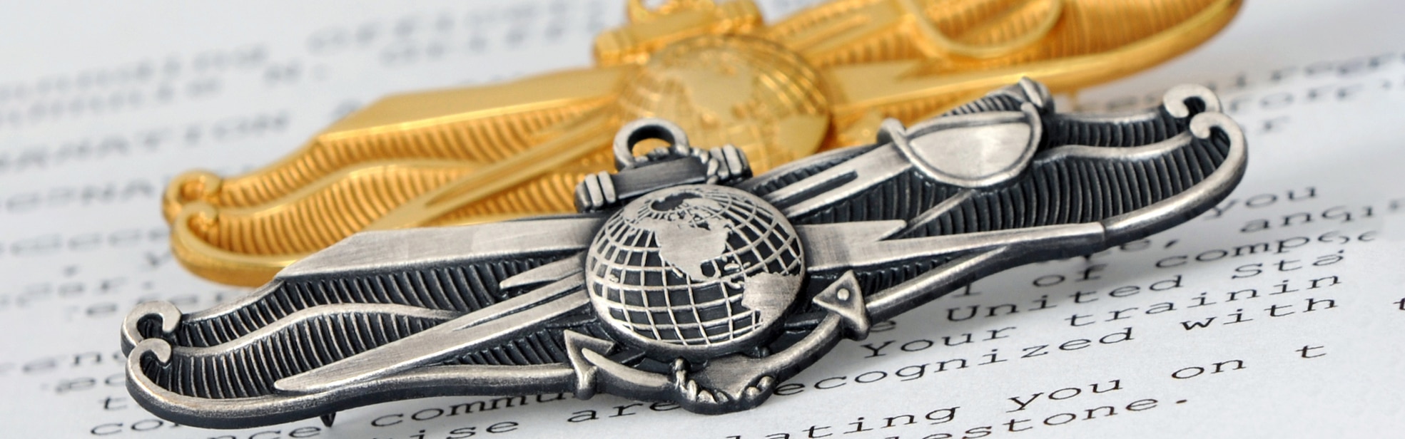 201019-N-5328N-003:  Officer’s Information Warfare Specialist (IWS) pin and the Enlisted IWS pin.  (U.S. Navy photo by Gary Nichols/Released) - photo was cropped to fit slide show & renamed201019-N-5328N-1003.