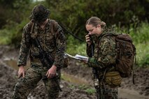 U.S. Marine Sgt. Wyatt Prentice (left) a fire control team chief and Capt. Kate Pearson (right) a firepower control team leader assigned to 1st Air Naval Gunfire Liaison Company, I Marine Expeditionary Force Information Group, I Marine Expeditionary Force communicates with higher headquarters during a brigade platoon field exercise on Marine Corps Base Camp Pendleton, California, April 7, 2020.