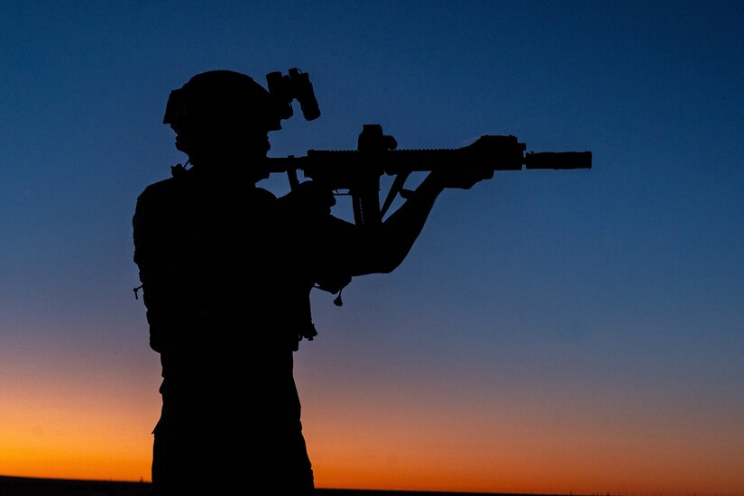 A silhouette of an airman holding a weapon.