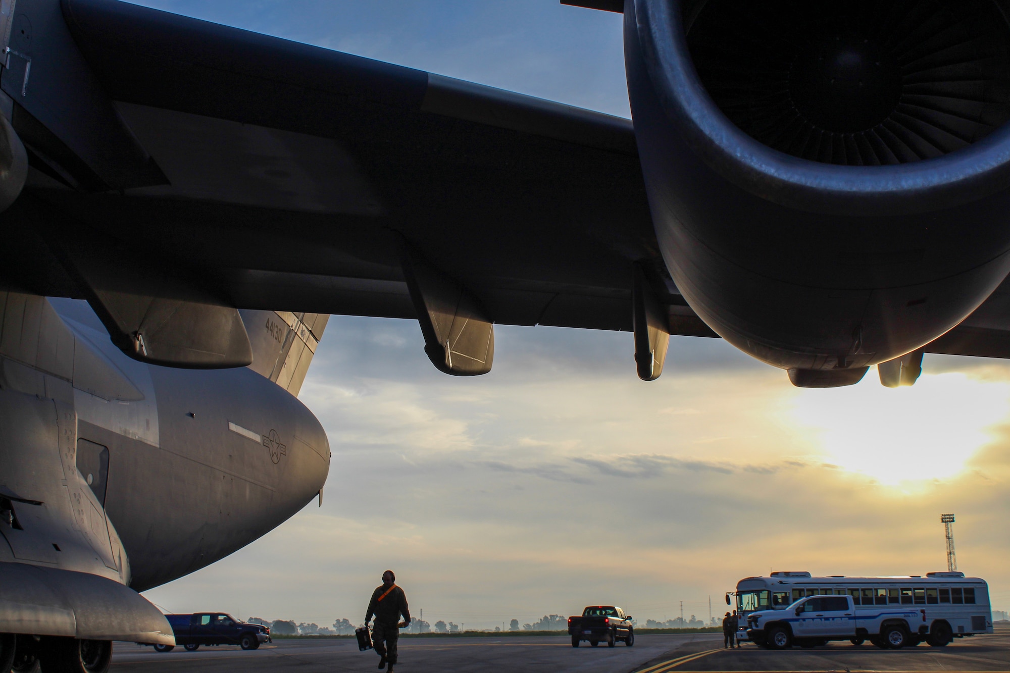 A U.S. Air Force service member walks towards the front of a C-17 Globemaster III during Exercise Rising Phoenix, Feb. 8, 2024, at Morón Air Base, Spain.