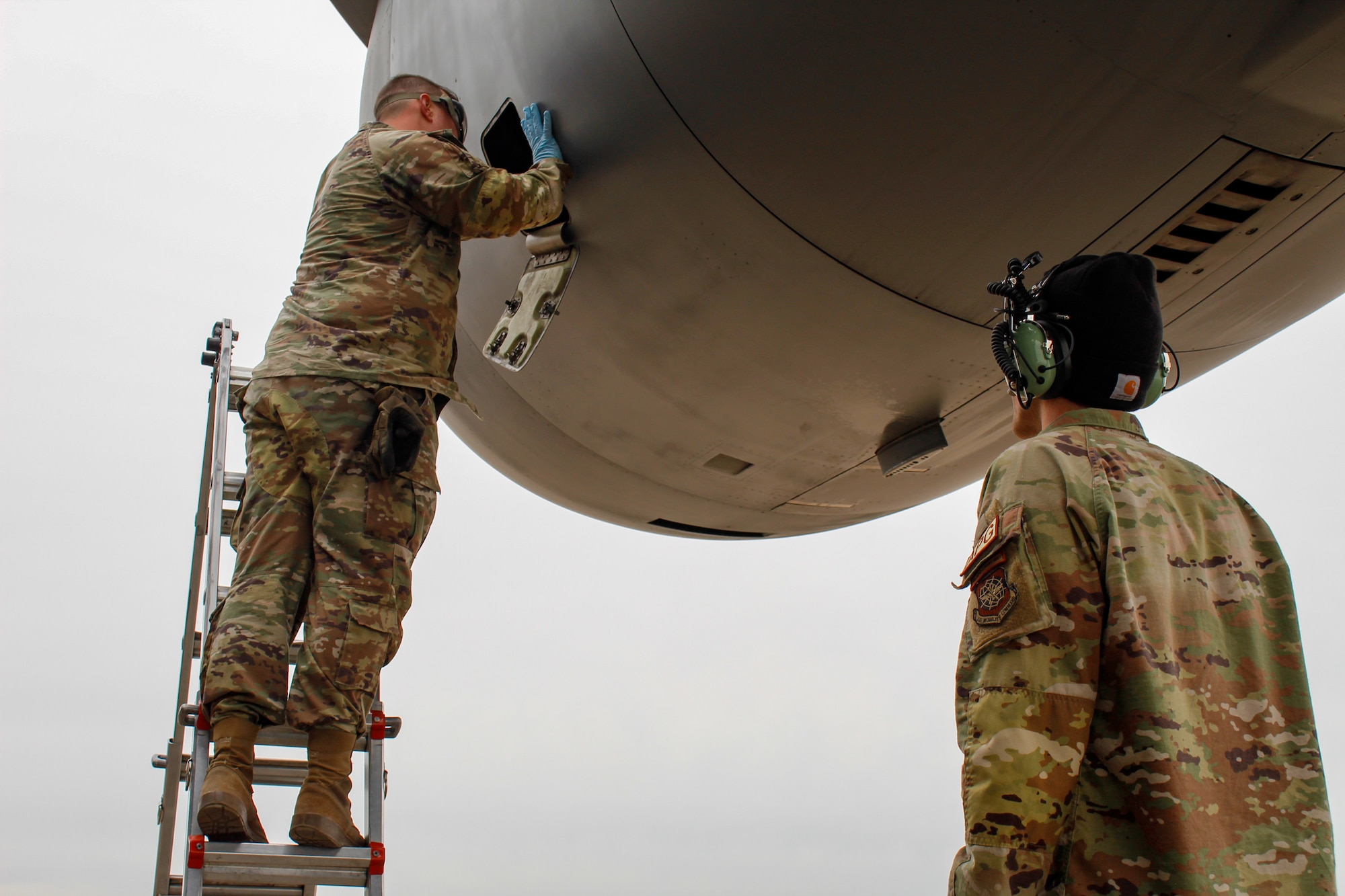 Two U.S. Air Force service member work on the engine of a C-17 Globemaster III during Exercise Rising Phoenix, Feb. 8, 2024, at Morón Air Base, Spain.