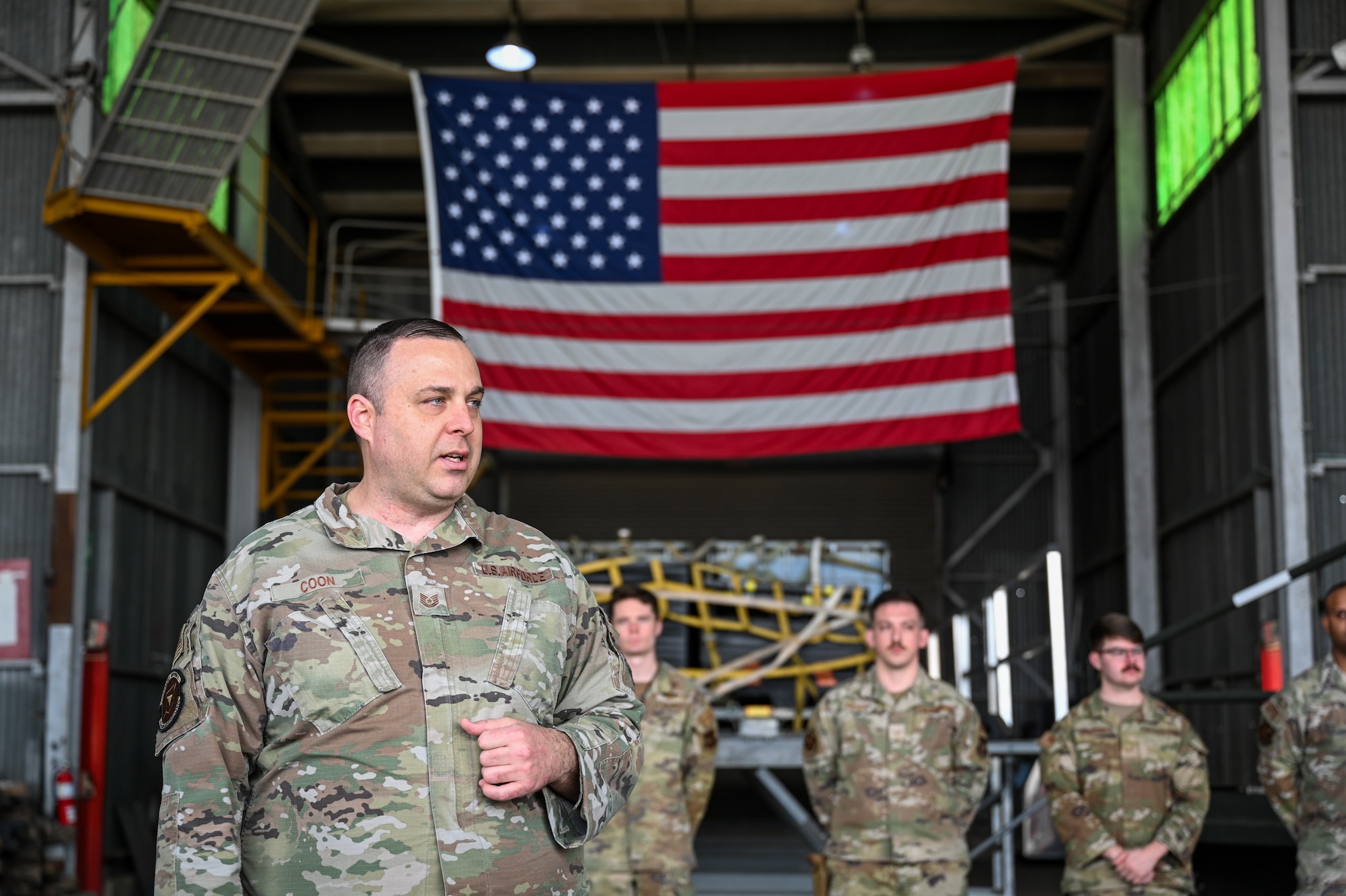 Tech. Sgt. Raymond Coon, 496th Air Base Squadron NCOIC of plans and programs, briefs distinguished visitors during Exercise Rising Phoenix, Feb. 7, 2024, at at Morón Air Base, Spain.