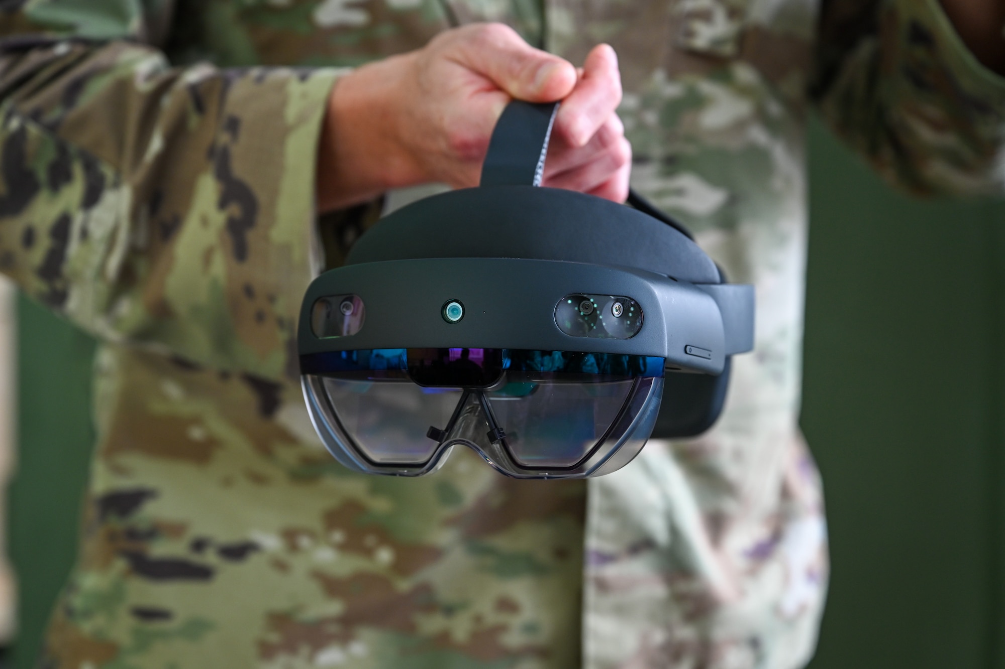 A HoloLens headset hangs from the hands of a U.S. Air Force service member during Exercise Rising Phoenix, Feb. 7, 2024, at Morón Air Base, Spain.