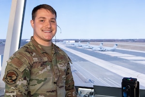 U.S. Air Force Senior Airman Cohen Bitner, 436th Operations Support Squadron air traffic control trainer, stands in the cab of the control tower at Dover Air Force Base, Delaware, March 11, 2024. Bitner was recognized as the 2023 Air Mobility Command Outstanding Air Traffic Control Airman of the Year. (U.S. Air Force photo by Roland Balik)