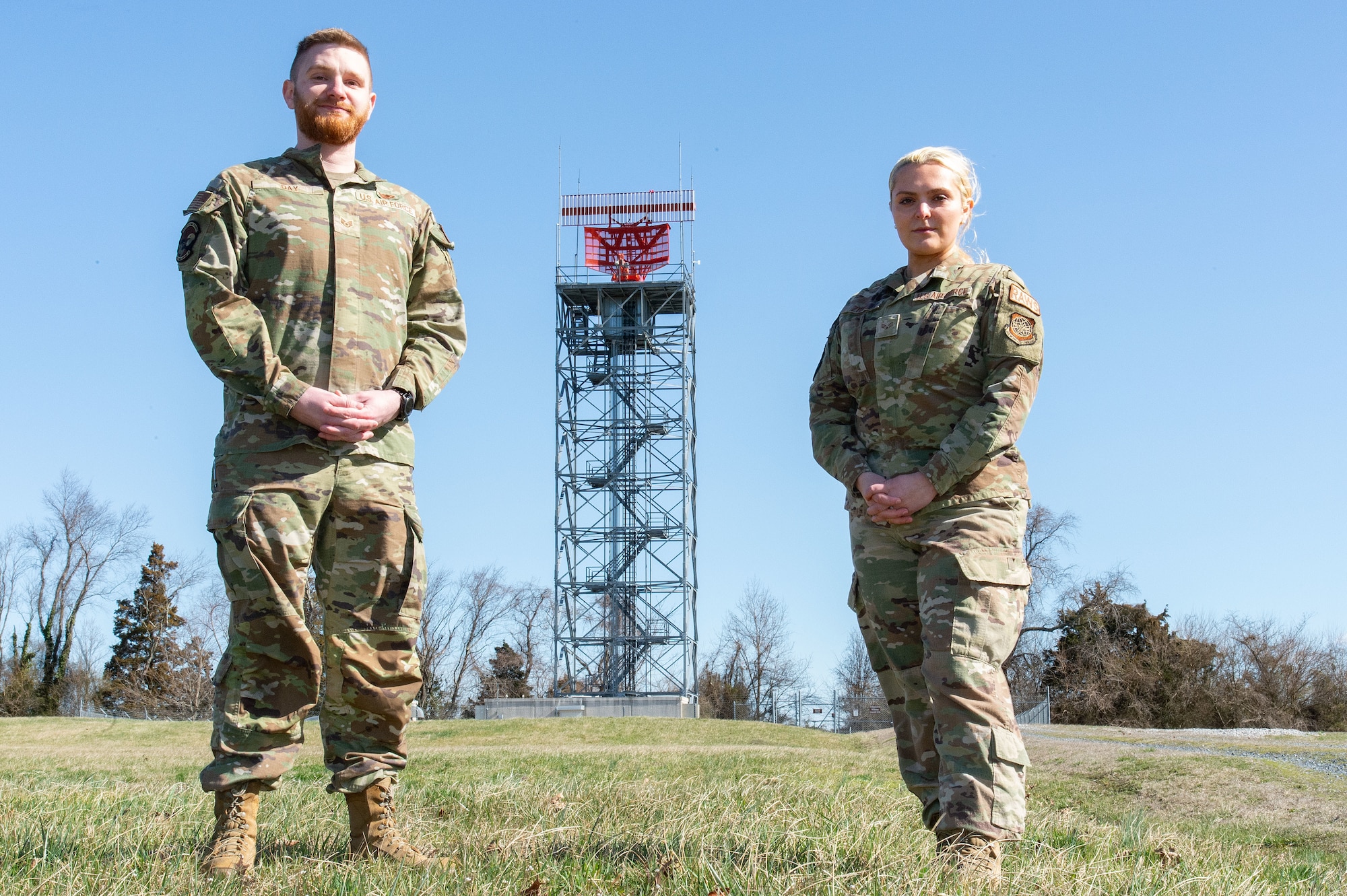 U.S. Air Force Staff Sgt. Colton Day, left, 436th Operations Support Squadron Radar, Airfield and Weather Systems supervisor and U.S. Air Force Senior Airman Alyssa Zydel, right, 436th OSS RAWS supervisor, stand near the radar tower at Dover Air Force Base, Delaware, March 11, 2024. Day was recognized as the 2023 Air Mobility Command RAWS Trainer of the Year and Zydel was recognized as the 2023 AMC RAWS Airman of the Year. (U.S. Air Force photo by Roland Balik)