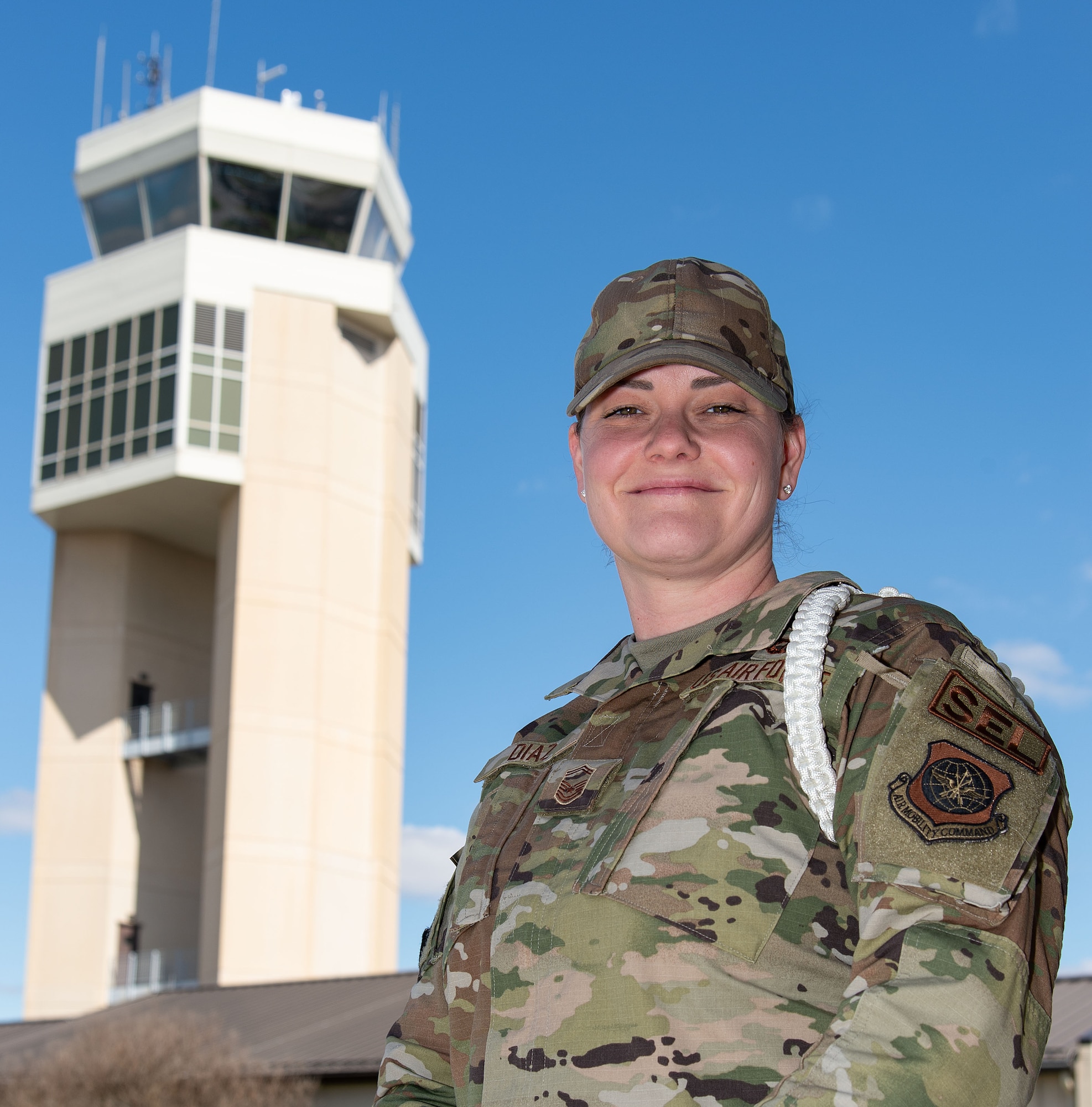 U.S. Air Force Senior Master Sgt. Abigail Diaz, 436th Operations Support Squadron senior enlisted leader, stands near the air traffic control tower at Dover Air Force Base, Delaware, March 19, 2024. Diaz was recognized as the 2023 Air Mobility Command ATC Senior Noncommissioned Officer of the Year. (U.S. Air Force photo by Roland Balik)