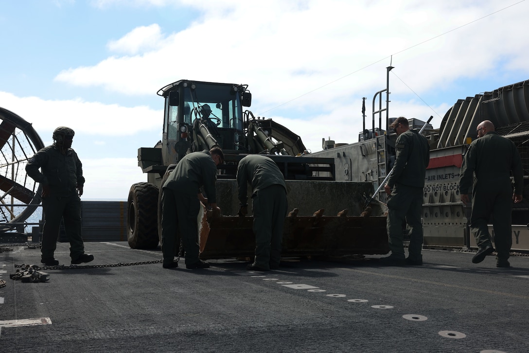 U.S. Marines with Marine Wing Support Squadron 373, Marine Air Control Group 38, 3rd Marine Aircraft Wing and U.S. Navy Sailors with Assault Craft Unit 5, load a tractor, rubber-tired, articulated steering, multi-purpose vehicle on a U.S. Navy Landing Craft, Air Cushion for transport from San Clemente Island to Camp Pendleton, California, Feb. 28, 2024.  ACU 5 helped transport 835,000 pounds of equipment across 58 nautical miles in support of MWSS-373's Strategic Mobility Exercise (STRATMOBEX) II. During STRATMOBEX II, MWSS-373 demonstrated mastery of scalable air-ground support such as expeditious airfield damage repair, forward arming and refueling, integrated engineering, and explosive ordnance disposal operations. 

(U.S. Marine Corps photo by Lance Cpl. Samantha Devine)