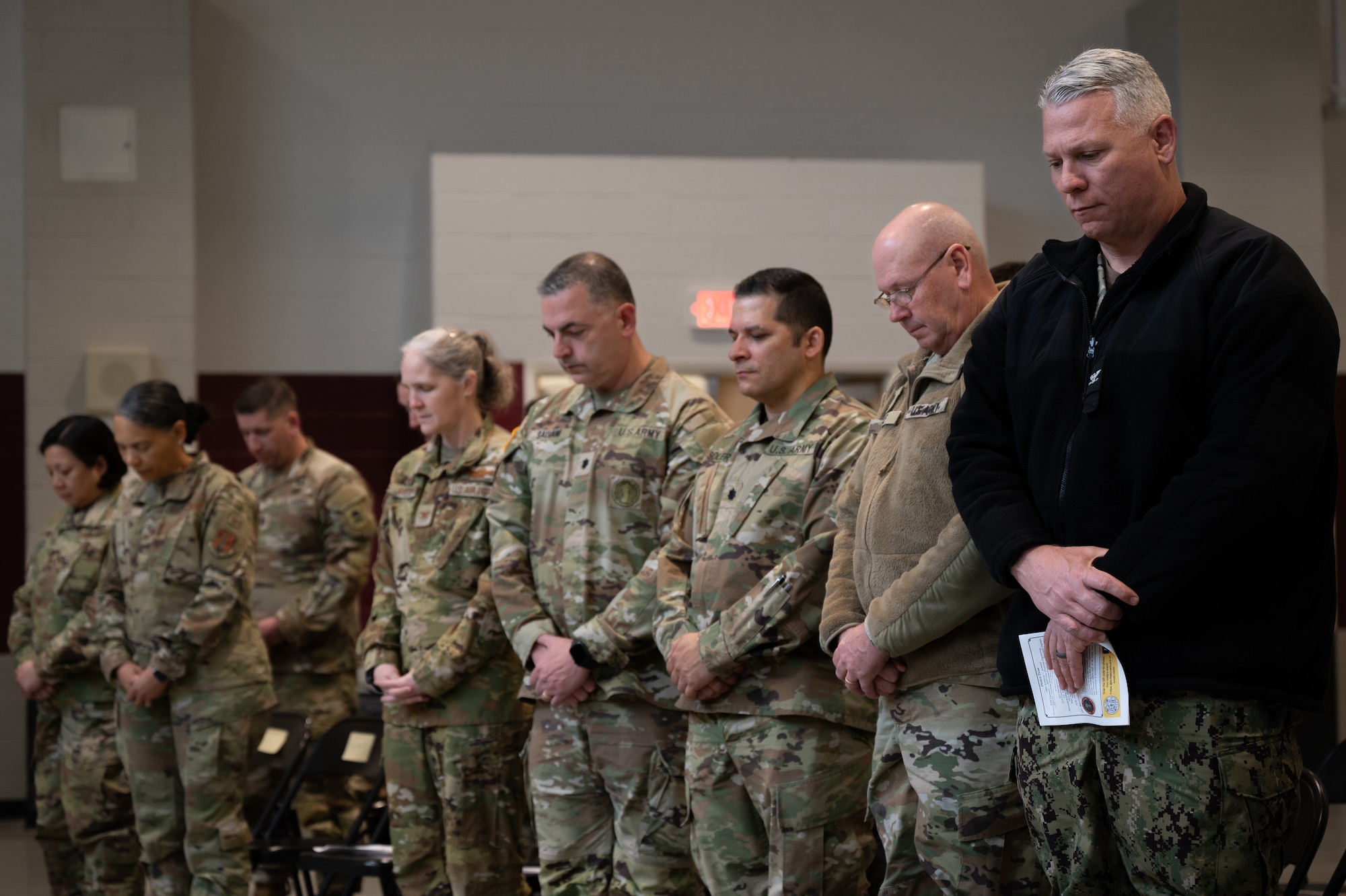 Leadership from Joint Base McGuire-Dix-Lakehurst, N.J., stand for the benediction during the groundbreaking ceremony at JB MDL, March 20, 2024. The 10,400-square-foot facility will support the 21st WMD-CST's training, administrative, and logistical requirements. This comprises administration, storage, classroom, locker room, break area, latrine/showers, parking, and maintenance areas. (U.S. Air Force photo by Airman 1st Class Aidan Thompson)