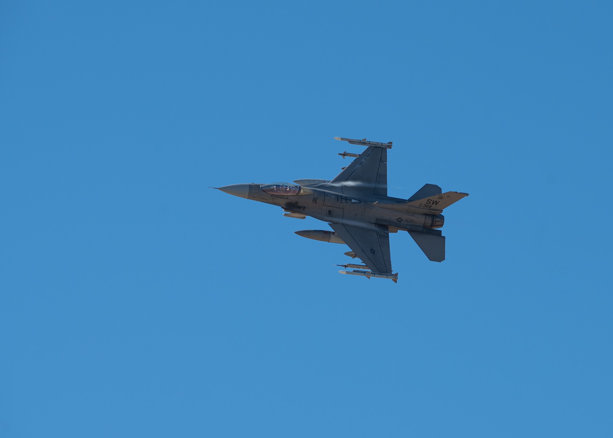 A jet flying sideways in the sky.