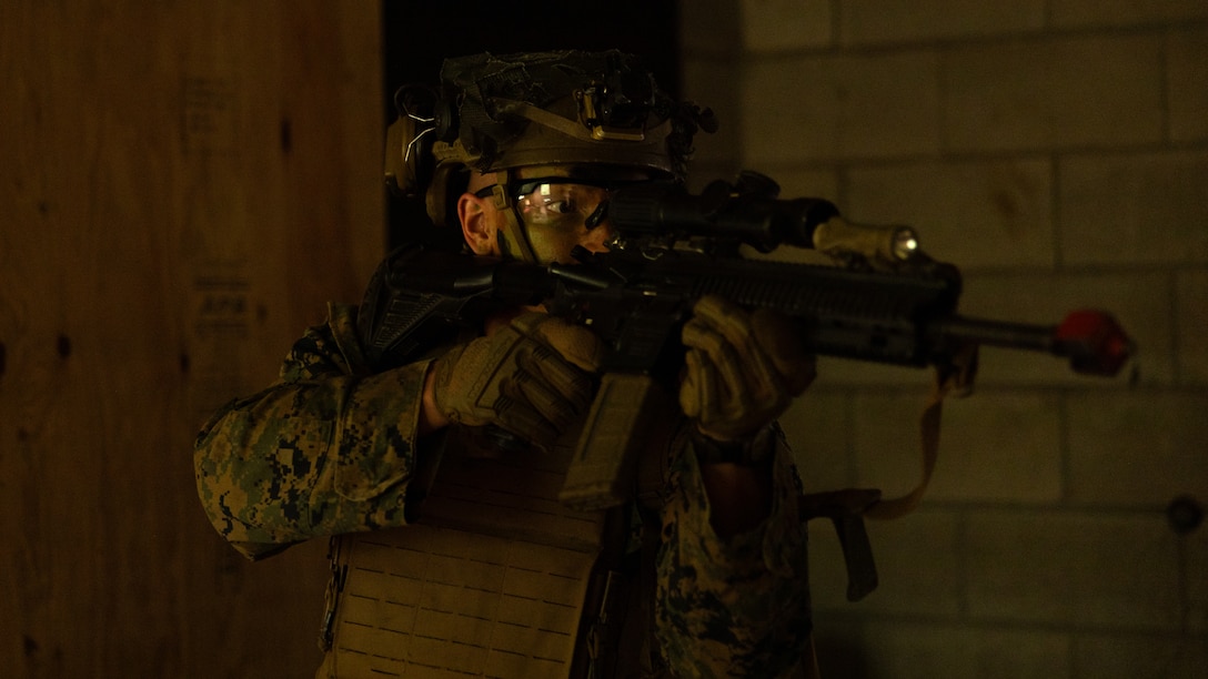 A U.S. Marine with 3d Littoral Combat Team, 3d Marine Littoral Regiment, 3d Marine Division defends a building during a force-on-force training event at Kahuku Training Area, Hawaii, March 6, 2024. 3d LCT provided an adversarial presence for students with Infantry Unit Leader Course 2-24, who were advancing skills in offensive tactical measures and operations. (U.S. Marine Corps photo by Sgt. Jacqueline C. Parsons)