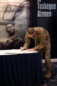 U.S. Air Force Col. Ryan Crowley, Joint Base Anacostia-Bolling and the 11th Wing commander, signs the Black History Month 2024 Proclamation in the Bolling Club on JBAB, Washington, D.C., Jan. 31, 2024. The proclamation calls to embrace diversity, foster inclusion, and strive for a society where every individual is treated with dignity and respect. (U.S. Photo by Staff Sgt. Brandon Schneider)