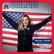 Woman in U.S. uniform holding American flag.