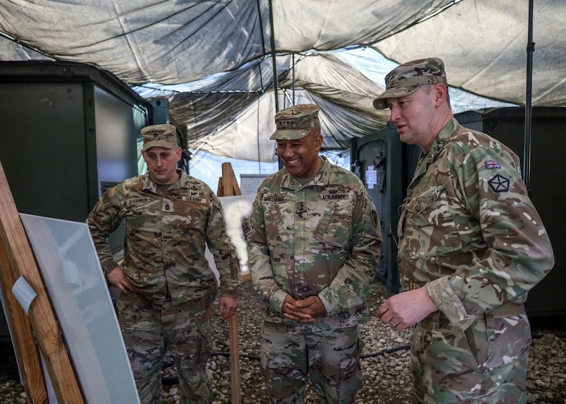 Gen. Darryl Williams (center), U.S. Army Europe and Africa commanding general, British Army Maj. Gen. Ollie Kingsbury (right), V Corps’ deputy commanding general of maneuver, and Command Sgt. Maj. Eric Bohannon (left), the V Corps forward senior enlisted leader, scan briefing materials March 8, 2024, during the “Warfighter” exercise held through March 15 at Grafenwoehr Training Area in Germany. The training served as the culminating exercise in a series of training events that demonstrates the versatility, technical skill and professional excellence of the corps staff and its ability to function seamlessly with allies and partners. (U.S. Army photo illustration by Spc. Devin Klecan)