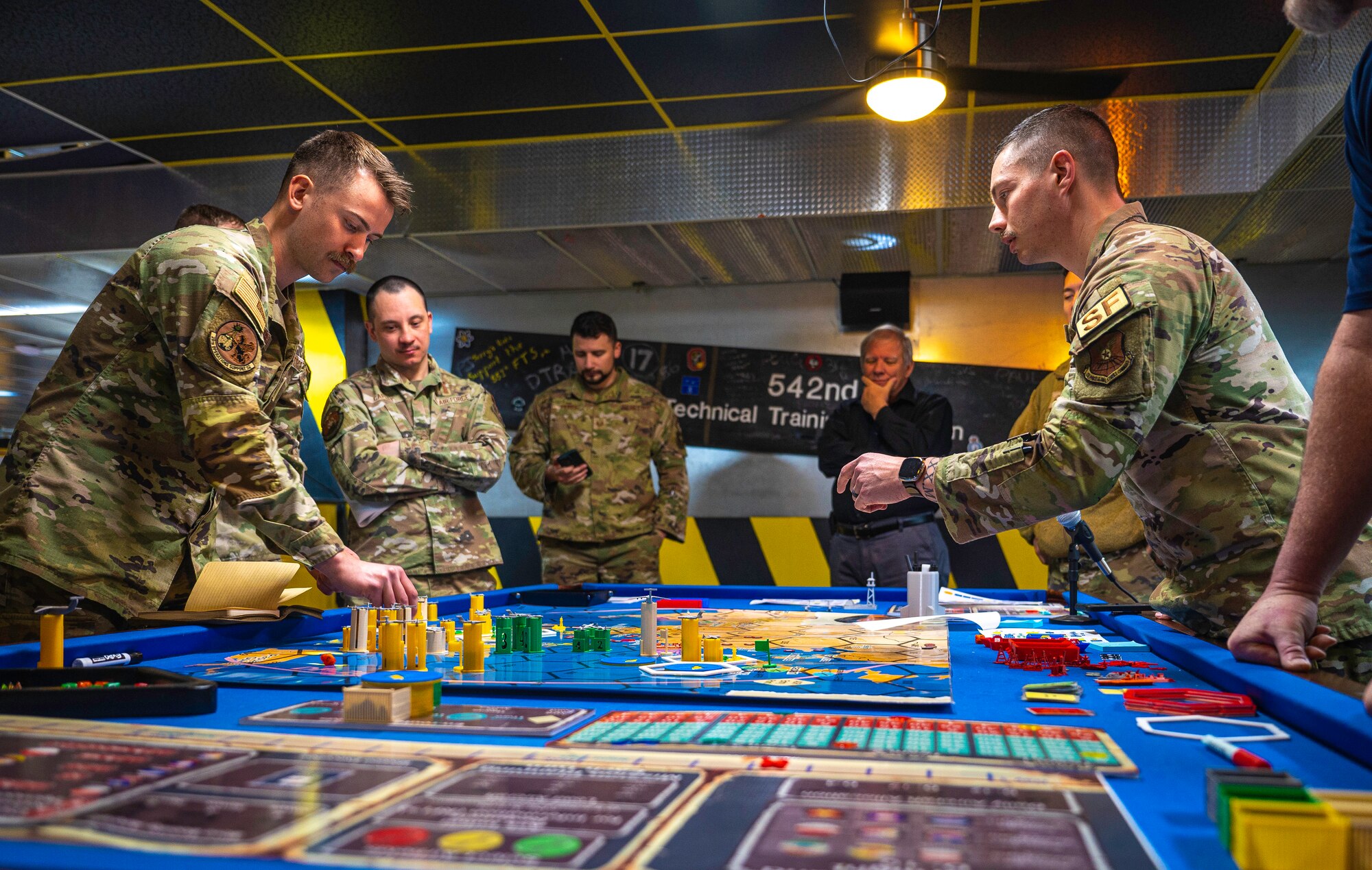 Men discuss a possible move during a board game.
