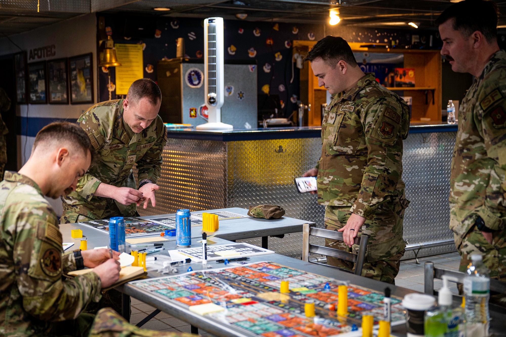 Men moving pieces on board game.