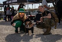 U.S. Marine Corps Cpl. Sarah Grawcock, a combat photographer and mascot handler with Headquarters and Service Battalion, Marine Corps Recruit Depot San Diego, and Pfc. Bruno, the mascot of MCRD San Diego and the Western Recruiting Region, pose for a photo at Snapdragon Stadium in San Diego, California, March 16, 2024. The mascot's job is to boost morale, participate in outreach work and attend events and ceremonies. (U.S. Marine Corps photo by Sgt. Jesse K. Carter-Powell)