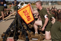 A U.S. Marine Corps recruit with Lima Company, 3rd Recruit Training Battalion, Recruit Training Regiment, steadies the guidon during a physical training event at Marine Corps Recruit Depot San Diego, California, March 19, 2024. Physical training challenges recruits to strengthen themselves physically and mentally. (U.S. Marine Corps photo by Cpl. Elliott A. Flood-Johnson)