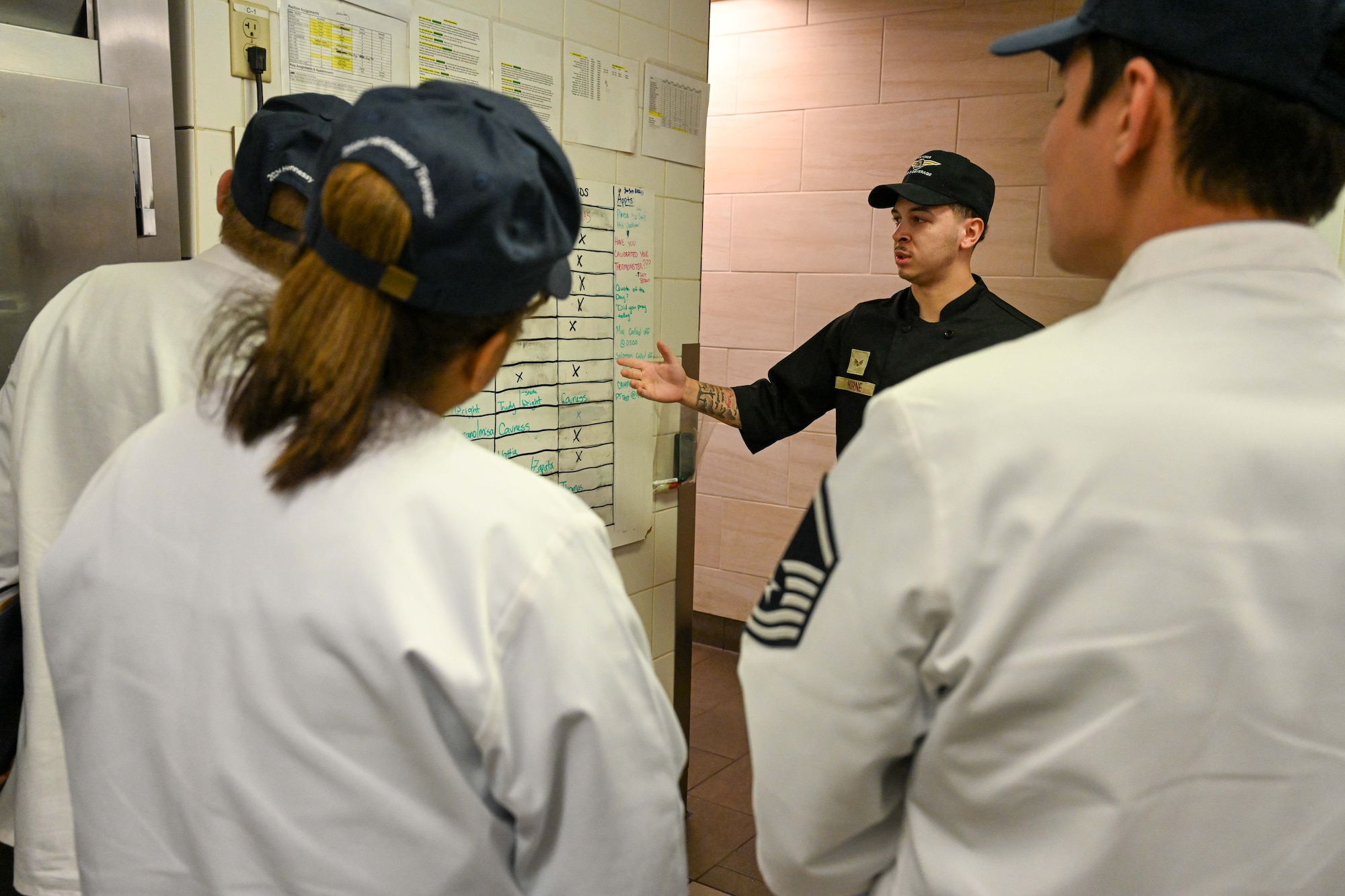 Senior Airman Anthony Horne, 22nd Force Support Squadron fitness apprentice, guides the Hennessy Award judges through the Chisholm Dining Facility at McConnell Air Force Base, Kansas, Feb. 15, 2024. The Hennessy Award is an annual recognition given to the base with the best dining facility in the Air Force. (U.S. Air Force photo by Airman 1st Class William Lunn)