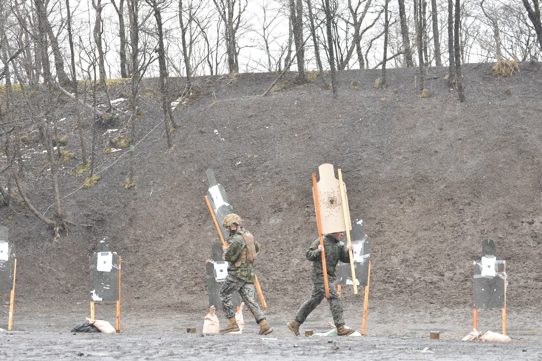 Marines assigned to Combined Arms Training Center, Camp Fuji, set-up new targets during a patrol rifle course, March 12, 2024.  (U.S. Marine Corps photo by Song Jordan)