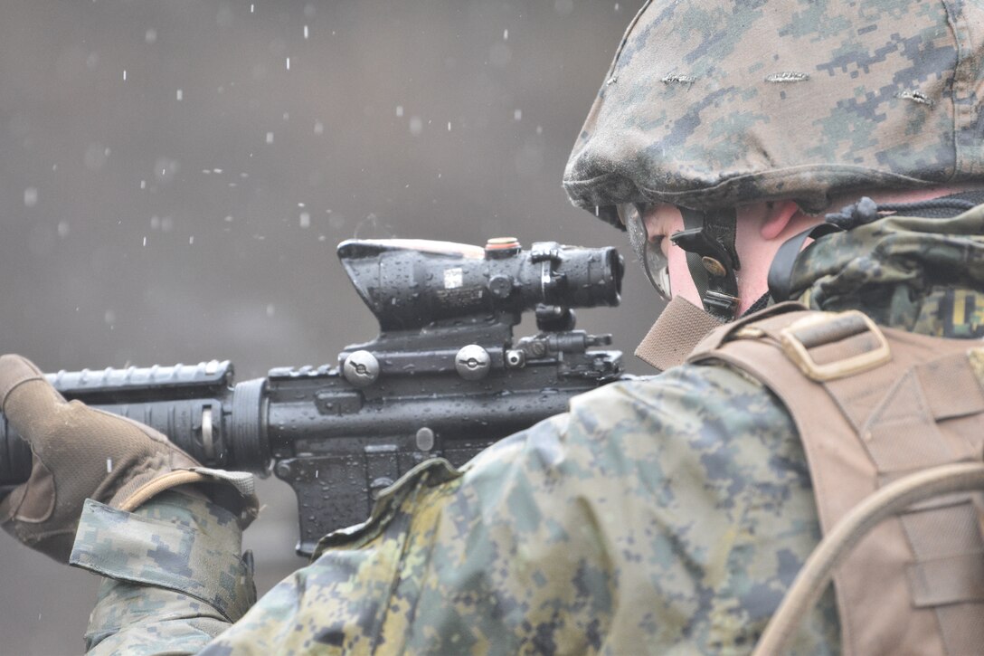 A Marine assigned to Combined Arms Training Center, Camp Fuji, peers down his rifle scope during a patrol rifle course, March 12, 2024.  (U.S. Marine Corps photo by Song Jordan)