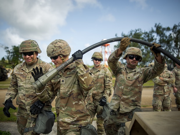 Soldiers assigned to E-3 Terminal High Altitude Area Defense Battery connect power cables during a Table VIII certification in Dededo, Guam, March 12, 2024. Table VIII is the first assessment in the series of gunnery tables that brings in external evaluators to assess the Battery's proficiency in their gunnery task as a collective. The THAAD battery, equipped with a state-of-the-art missile defense system, is tasked with defending Guam against ballistic missile threats. (U.S. Army Photo by Maj. Trevor Wild)