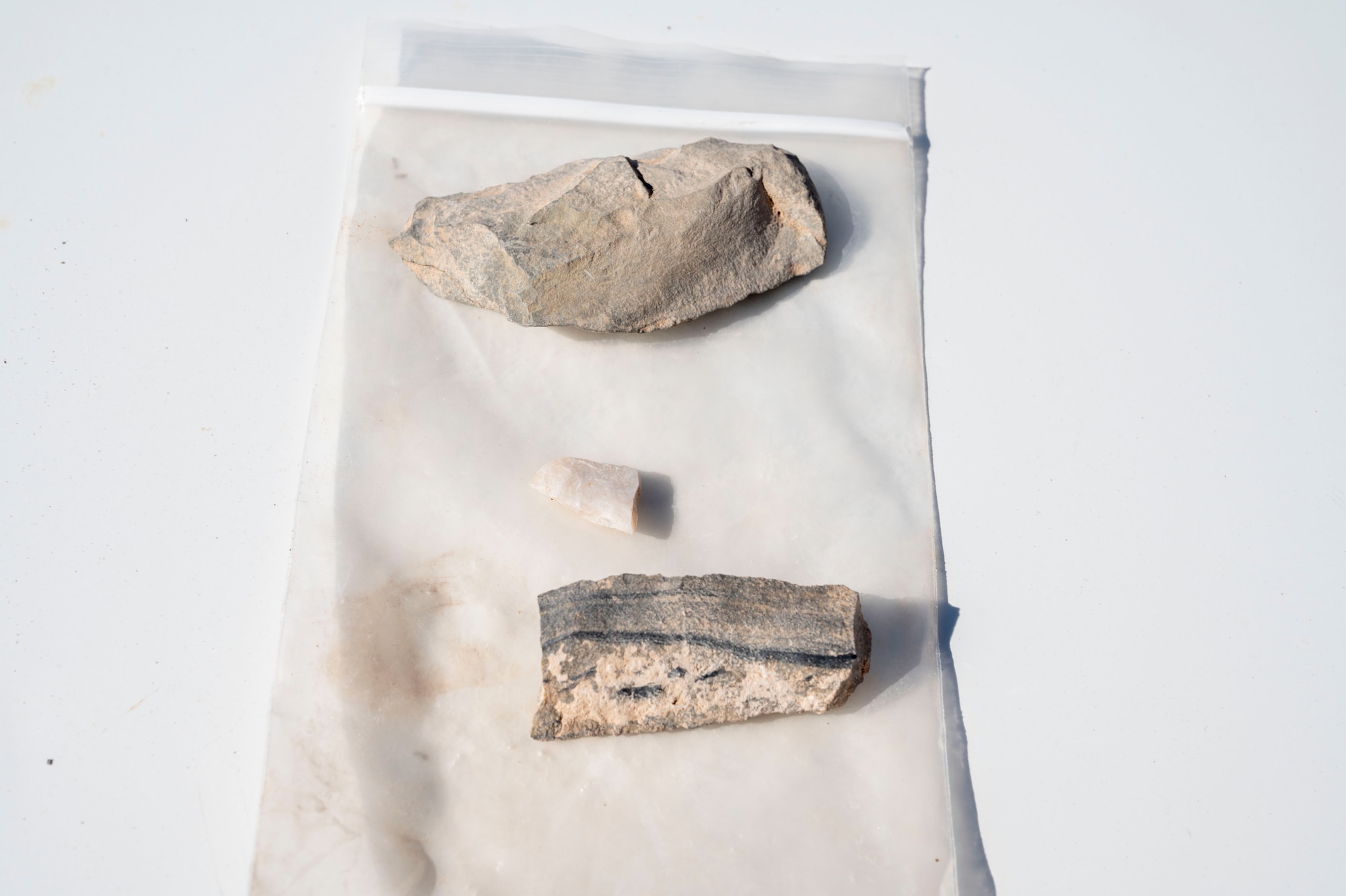 Fragments found at the Paleo-Archaic site recovered by members of the 49th Civil Engineer Squadron environmental flight at Holloman Air Force Base, New Mexico, Mar. 7, 2024. The site named Gomolak Overlook is believed to be approximately 8,200 years old and is one of the oldest sites uncovered in the Tularosa Basin. (U.S. Air Force photo by Airman 1st Class Isaiah Pedrazzini)