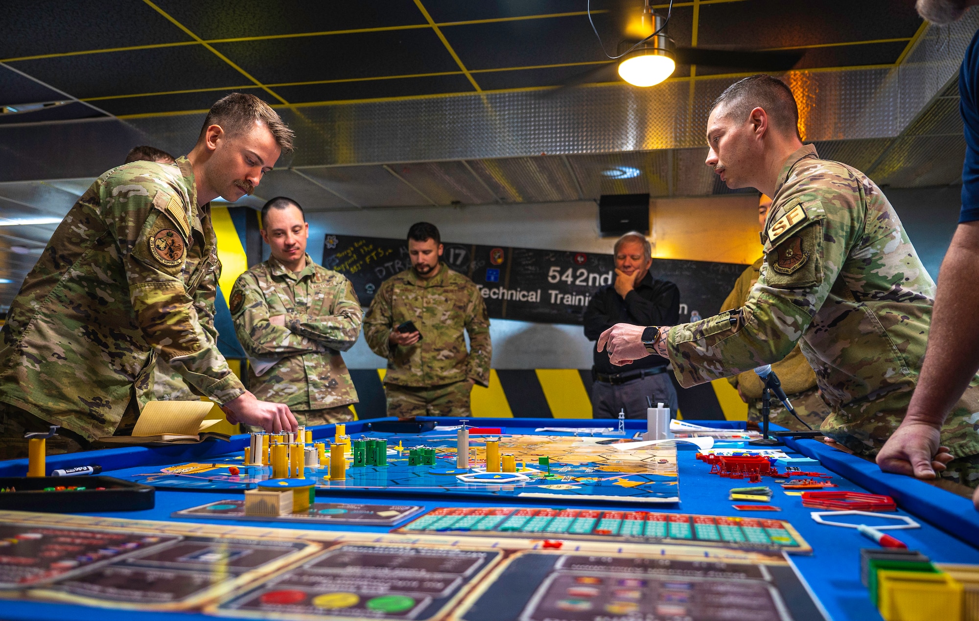 Men discuss a possible move during a board game.