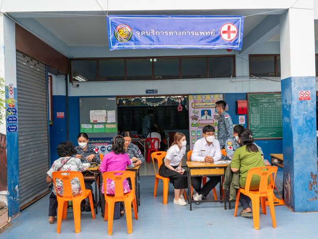 Locals begin the check-in process during a community outreach event for Cope Tiger 2024, Ban Krok Duan Ha School, Nakhon Ratchasima Province, Thailand, March 21, 2024. While the ceremony and games were taking place with the students, medical professionals from the Royal Thai Air Force and Republic of Singapore Air Force rendered care to locals with support from the U.S. Air Force medical team. (U.S. Air Force photo by Tech. Sgt. Hailey Haux)