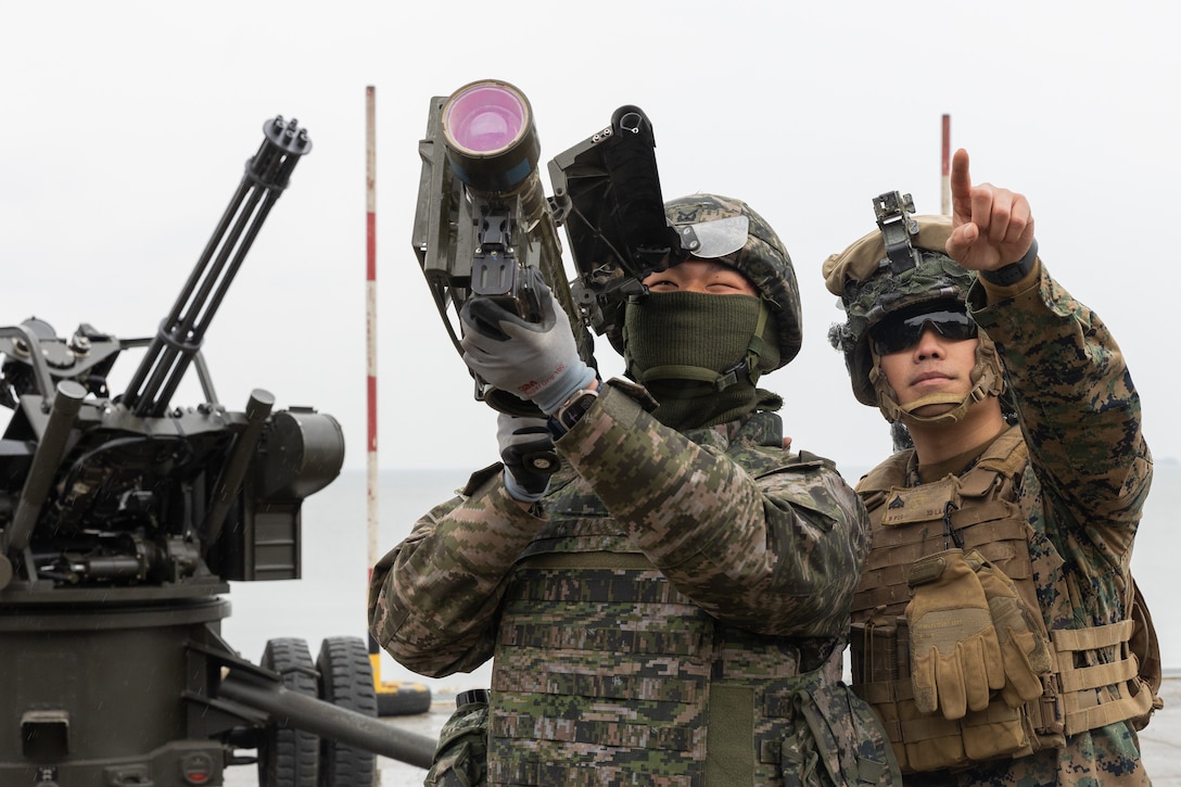U.S. Marine Corps Cpl. Johnathan Saechao, a low altitude air defense gunner, with 3rd Low Altitude Air Defense Battalion, 3rd Marine Air Wing, and a ROK Marine practice firing a Stinger Trainer Launch Simulator during Warrior Shield 24 on Daecheon Firing Range, Republic of Korea March 5, 2024. Warrior Shield 24 is an annual joint, combined exercise held on the Korean Peninsula that seeks to strengthen the combined defensive capabilities of ROK and U.S. forces. This routine, regularly scheduled, field training exercise provides the ROK and U.S. Marines the opportunity to rehearse combined operations, exchange knowledge, and demonstrate the strength and capabilities of the ROK-U.S. Alliance. Saechao is a native of California. (U.S. Marine Corps photo by Lance Cpl. Jeffrey Pruett)