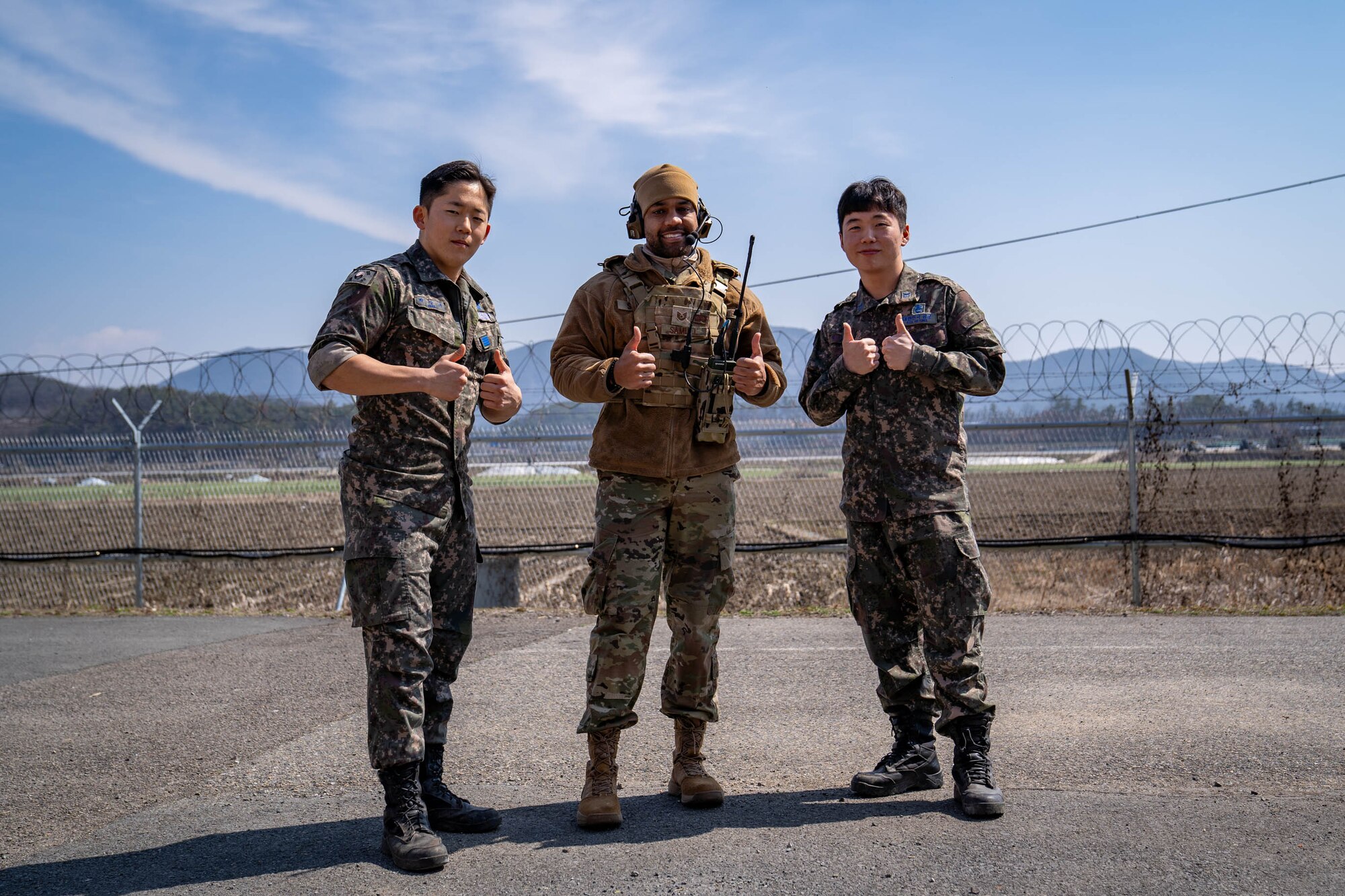 U.S. Air Force Tech. Sgt. James Samuel, 51st Operations Support Squadron senior watch supervisor, poses for a photo with members of the Republic of Korea Air Force during an emergency landing site training event near Namji, ROK, March 13, 2024.