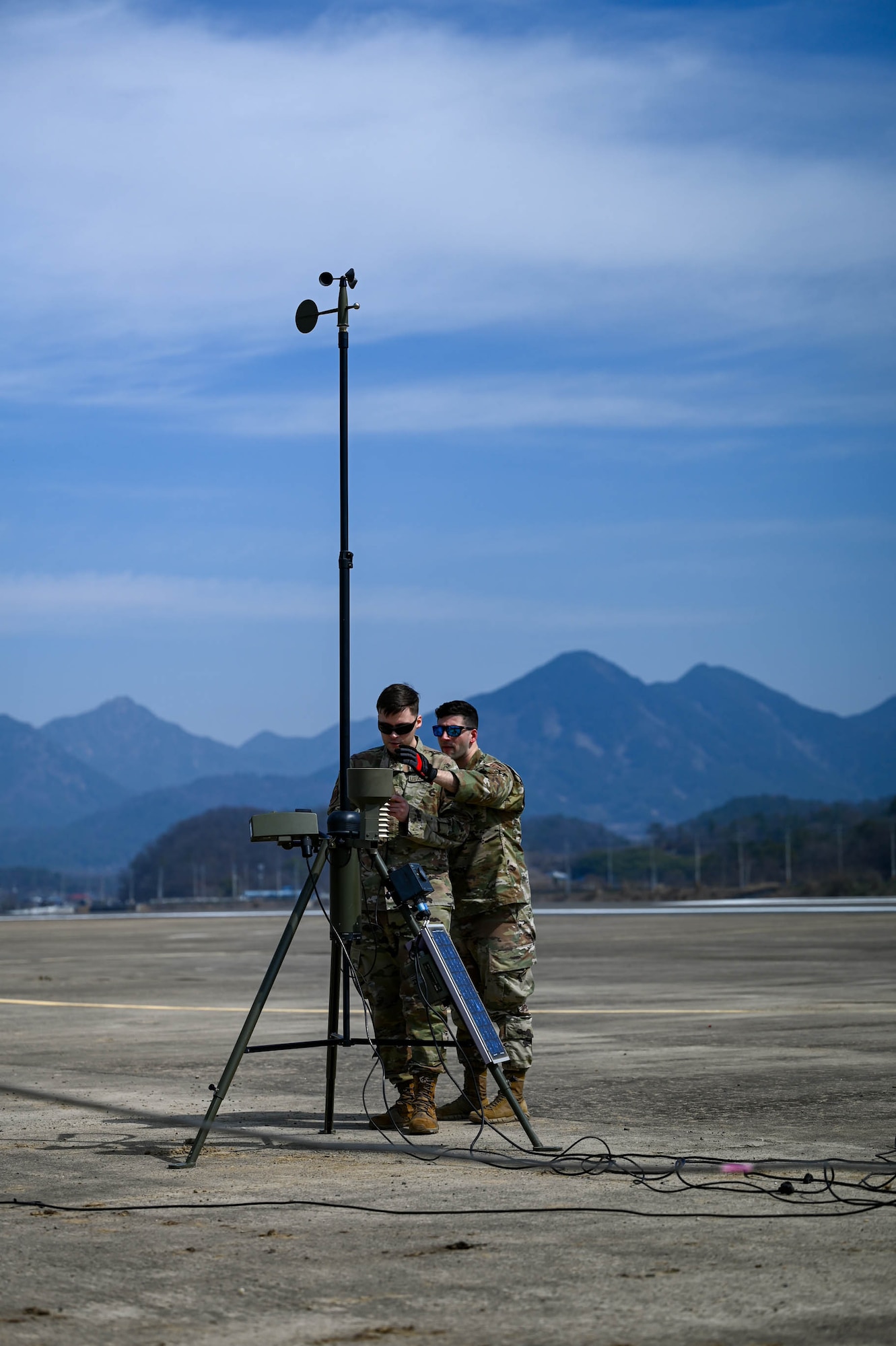 U.S. Air Force Staff Sgts. Race Gardner and Anthony Thornton, 51st Operations Support Squadron weather craftsmen, monitor weather equipment at an emergency landing site training event near Namji, Republic of Korea, March 13, 2024.