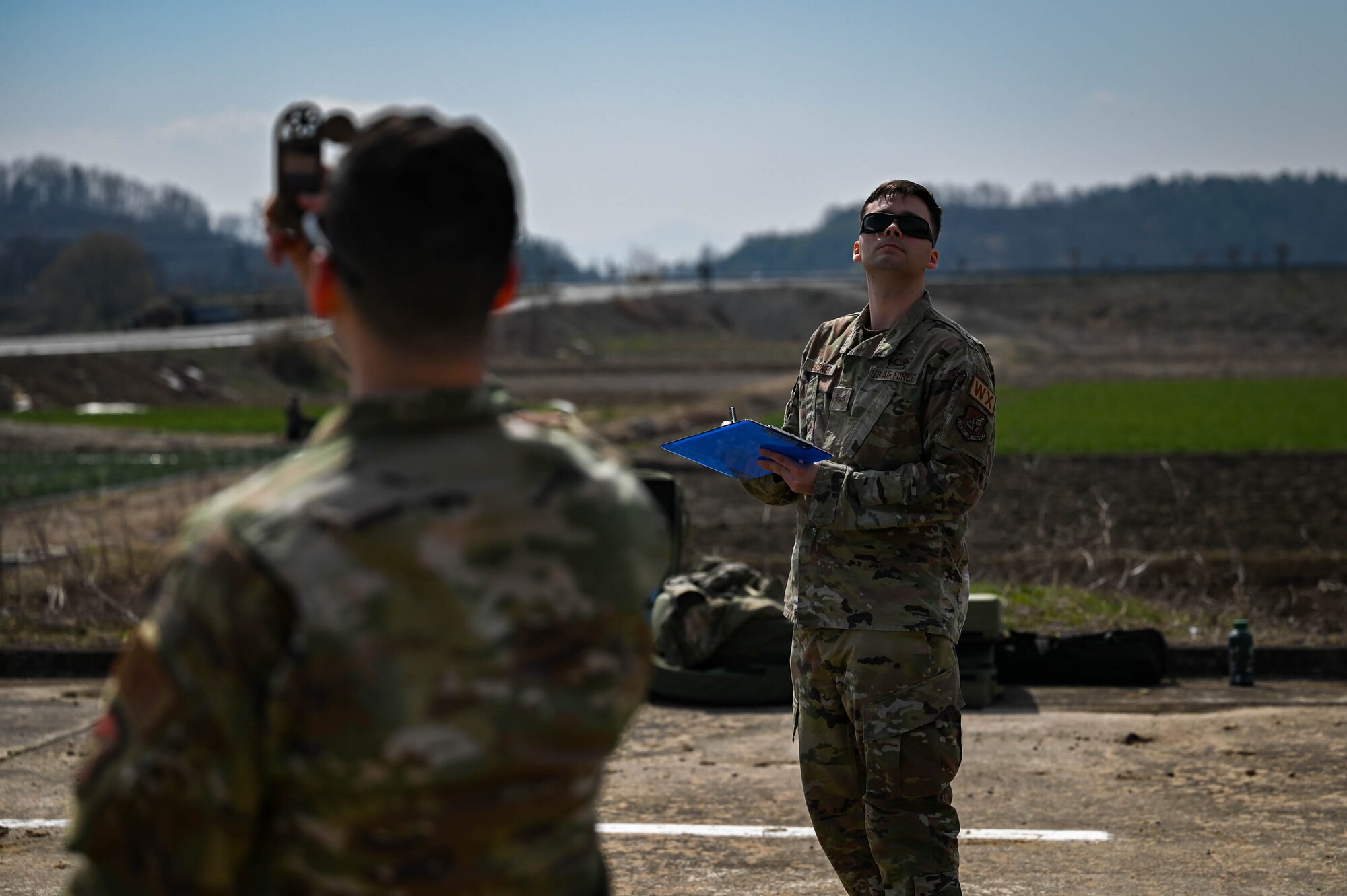 U.S. Air Force Staff Sgts. Race Gardner and Anthony Thornton, 51st Operations Support Squadron weather craftsmen, monitor weather equipment at an emergency landing site training event near Namji, Republic of Korea, March 13, 2024.