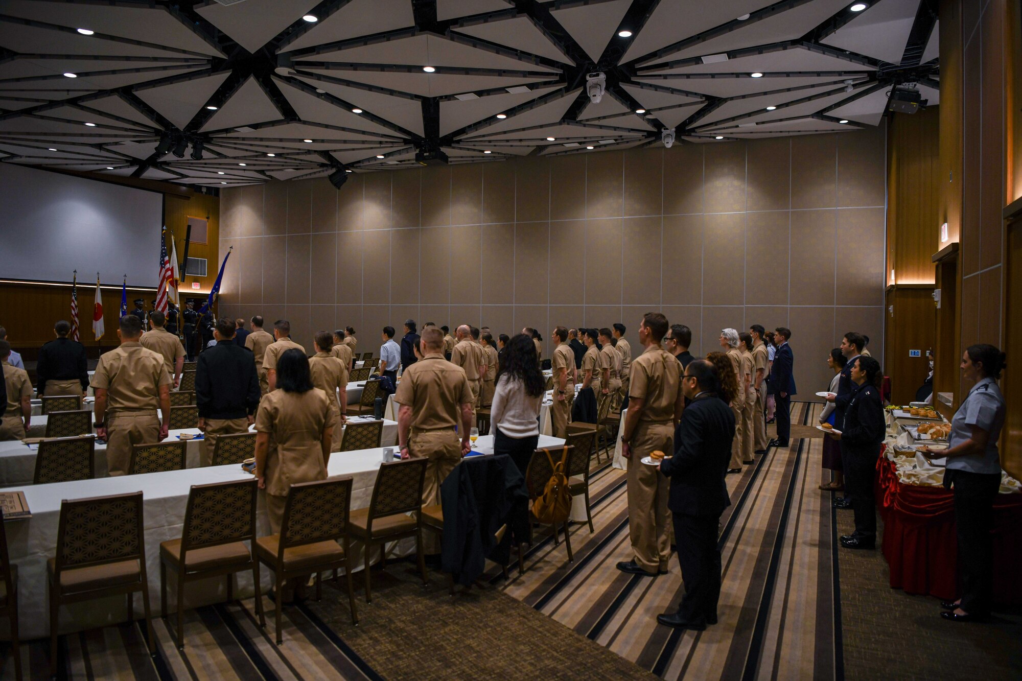 Service members stand at attention.