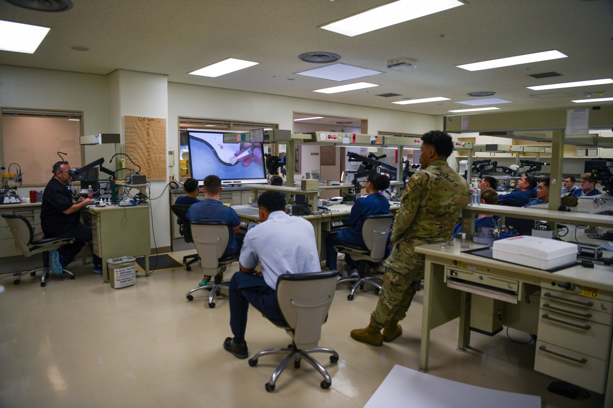 A group of service members pay attention to a lecture.