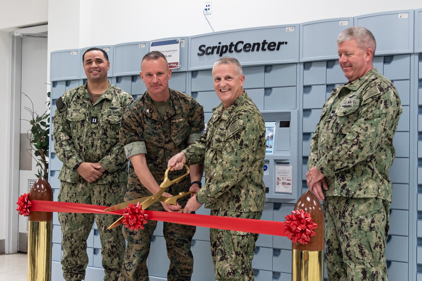 U.S. Marine Col. Brendan Burks, center left, MCAS Cherry Point commanding officer, and Navy Capt. Sean Barbabella, center right, commanding officer of Naval Health Clinic Cherry Point, cut a ribbon marking the official opening of the installation’s ScriptCenter on Thursday, March 21, 2024.

ScriptCenters are contactless, automated lockers employing state-of-the-art technology and provide convenient and secure access to most prescriptions. Cherry Point’s ScriptCenter is inside the Marine Corps Exchange building, adjacent to the internal Commissary entrance.