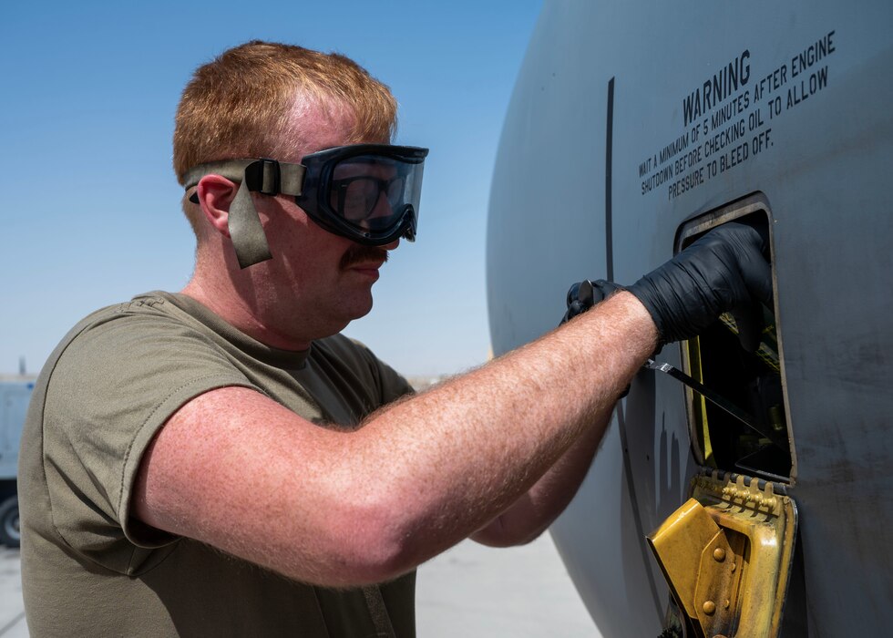 U.S. Air Force crew chief adds oil to a KC-135 Stratotanker engine at an undisclosed location in the U.S. Central Command area of responsibility, Mar. 21, 2024. Crew chiefs are responsible for the maintenance and upkeep of aircraft, ensuring they are in optimal condition for missions. (U.S. Air Force photo)