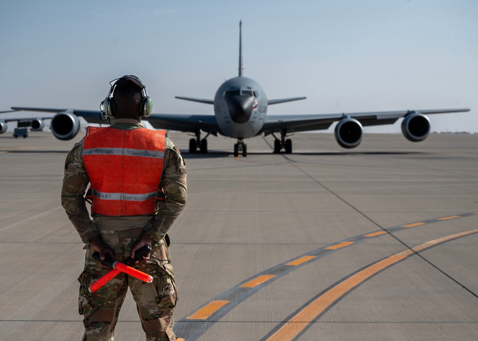 U.S. Air Force crew chief waits to marshal a KC-135 Stratotanker at an undisclosed location in the U.S. Central Command area of responsibility, Mar. 21, 2024. The Crew chief marshaled the aircraft to navigate them and ensure safety, prevent collisions, and maintain efficient operations. (U.S. Air Force photo)