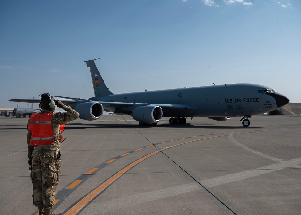 A U.S. Air Force crew chief salutes a KC-135 Stratotanker at an undisclosed location in the U.S. Central Command area of responsibility, Mar. 21, 2024. Saluting an aircraft is a traditional gesture of respect and acknowledgment carried out by crew chiefs, symbolizing the dedication and honor they hold for their aircraft and its mission. (U.S. Air Force Courtesy Photo)