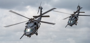 Two HH-60G Pave Hawk helicopters carrying 920th Rescue Wing spouses take off