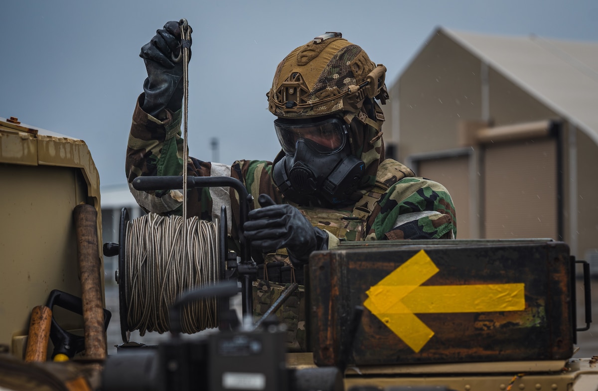 U.S. Air Force Staff Sgt. Kelly Dishman, 325th Civil Engineer Squadron explosive ordnance disposal journeyman, pulls a rope in preparation for disarming a simulated explosive during exercise Crown Royal 24-2 at Tyndall Air Force Base, Fla., March 5, 2024. CR 24-2 was the first wing-wide Air Force Force Generation model exercise at the 325th Fighter Wing. The AFFORGEN model is designed to improve readiness for combat situations and improve the capabilities the Air Force provides to the joint force. (U.S. Air Force photo by Airman 1st Class Zeeshan Naeem)